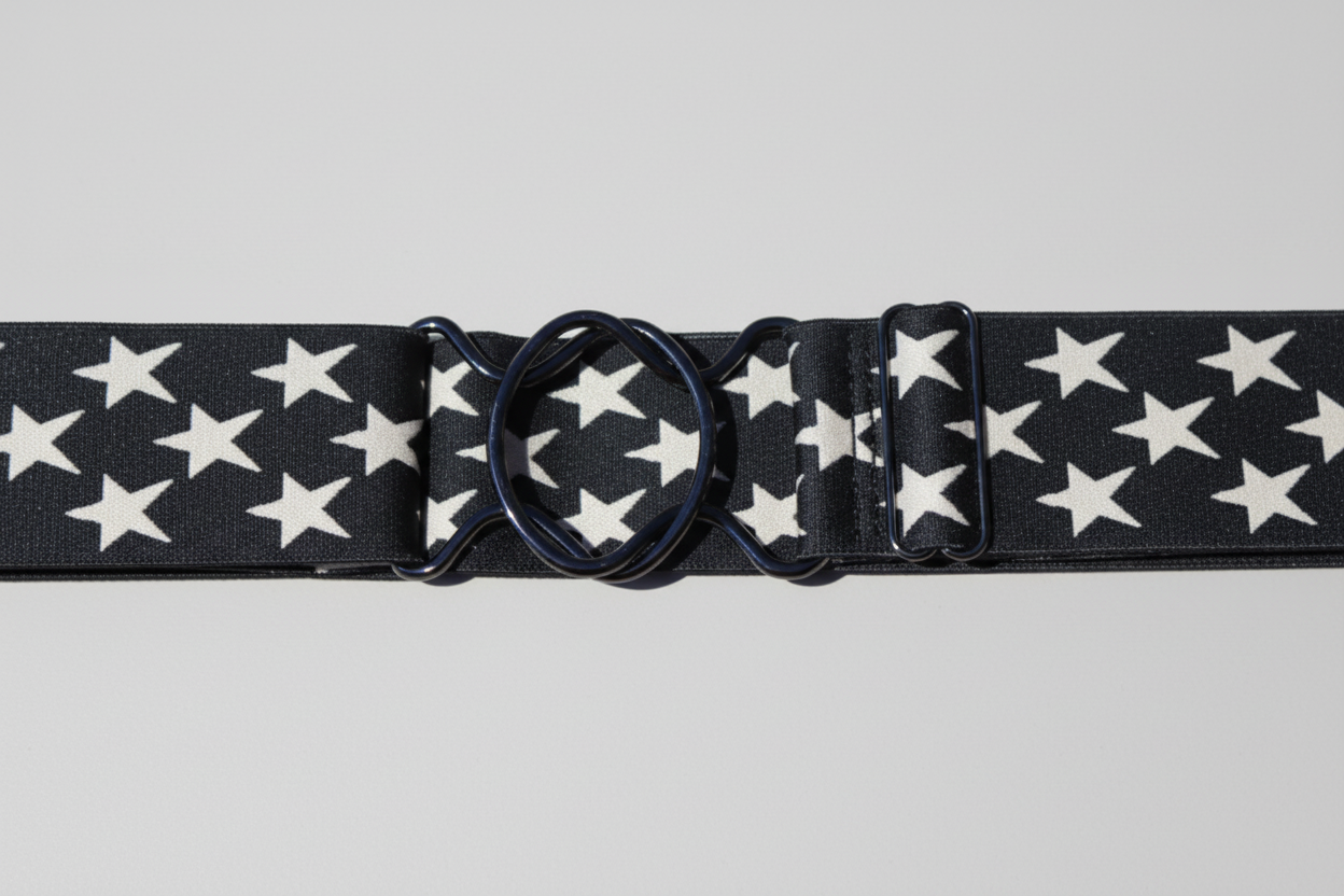 Black belt with white star pattern and metal buckle on a white background