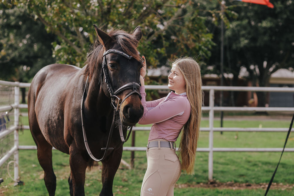 Finley Wright wearing Divine Equestrian Lilac Sweet Lady Sun Shirt, Gray Comfort Fit Elastic Belt, and Beige Comfort Grip Leggings