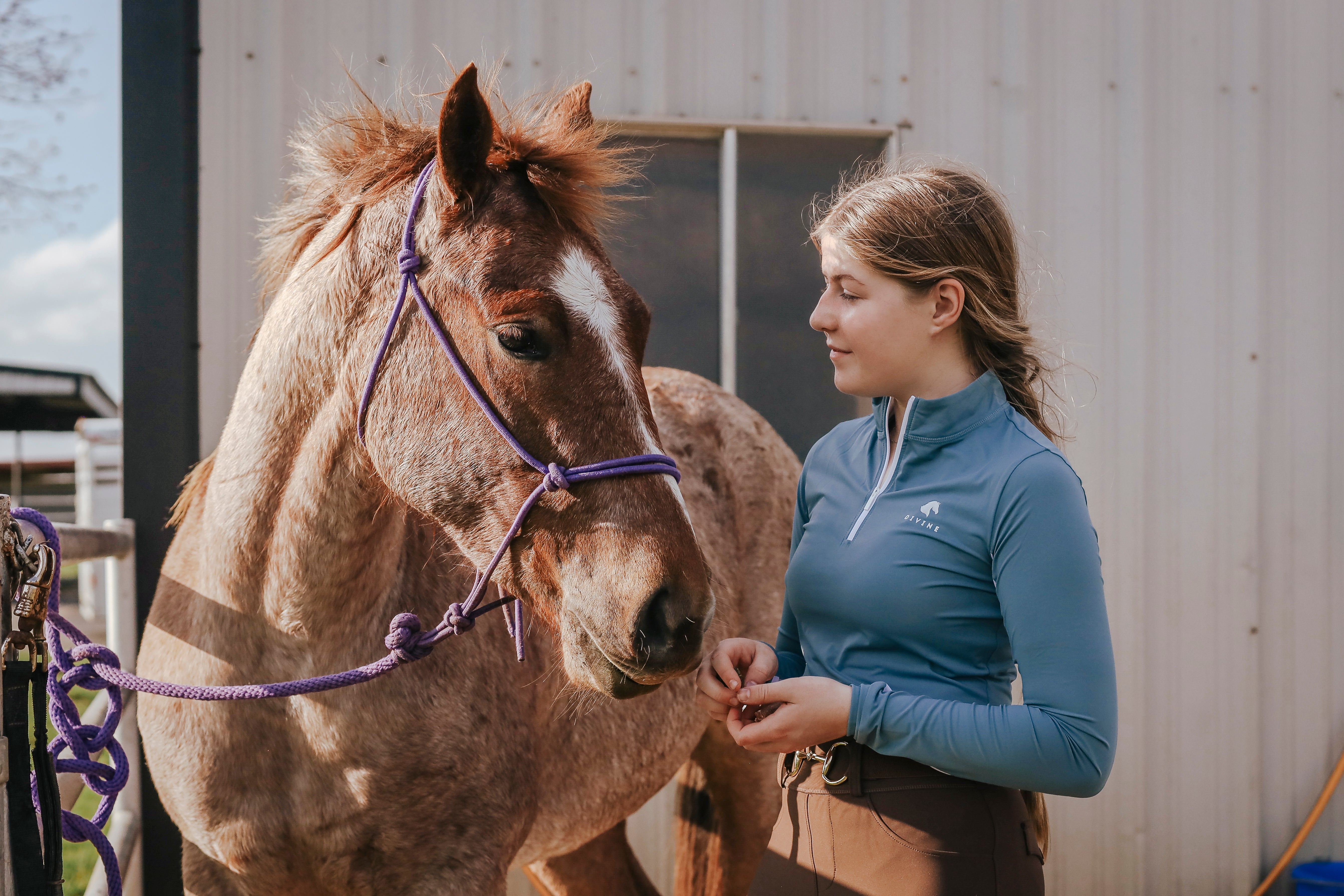 Finley Wright wearing Divine Equestrian Steel Blue Sweet Lady Sun Shirt, Brown Comfort Fit Belt, and Mocha Comfort Grip Leggings