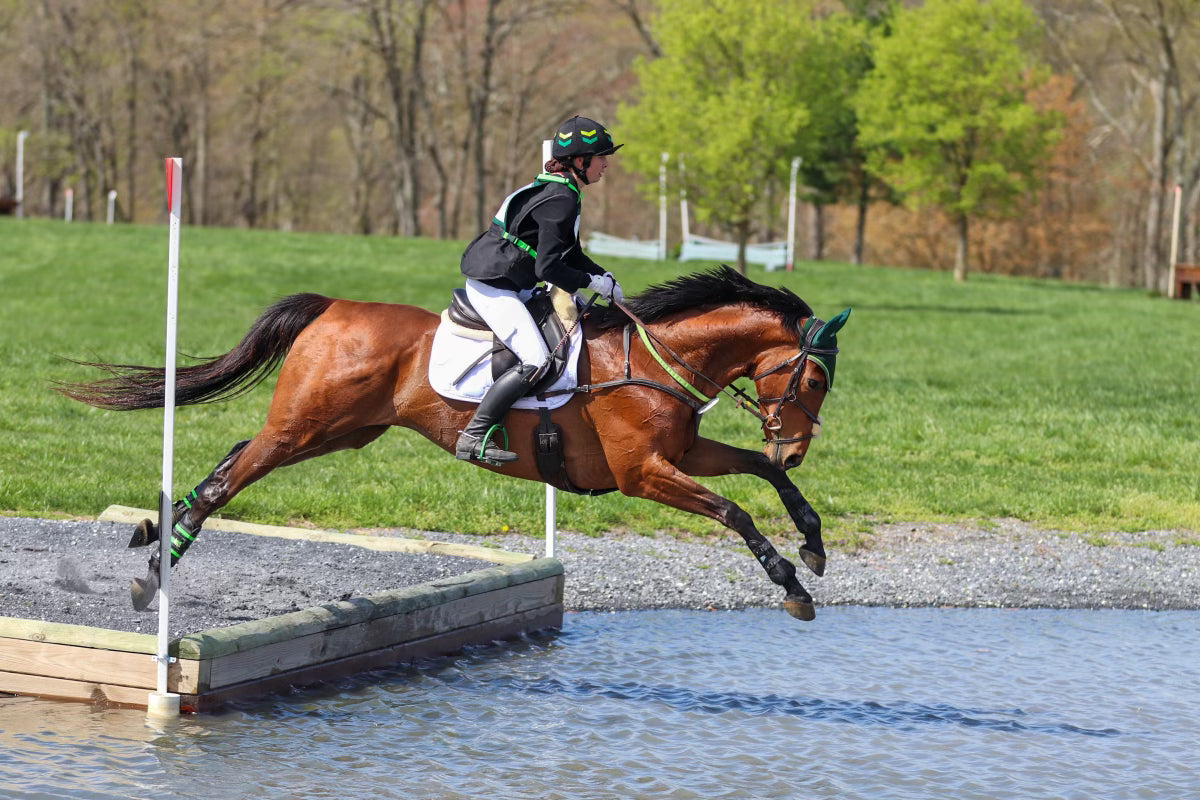 Sutton Wetcher wearing Divine Equestrian White Dignified Competition Breeches and Black 2 in 1 Jacket while competing cross country