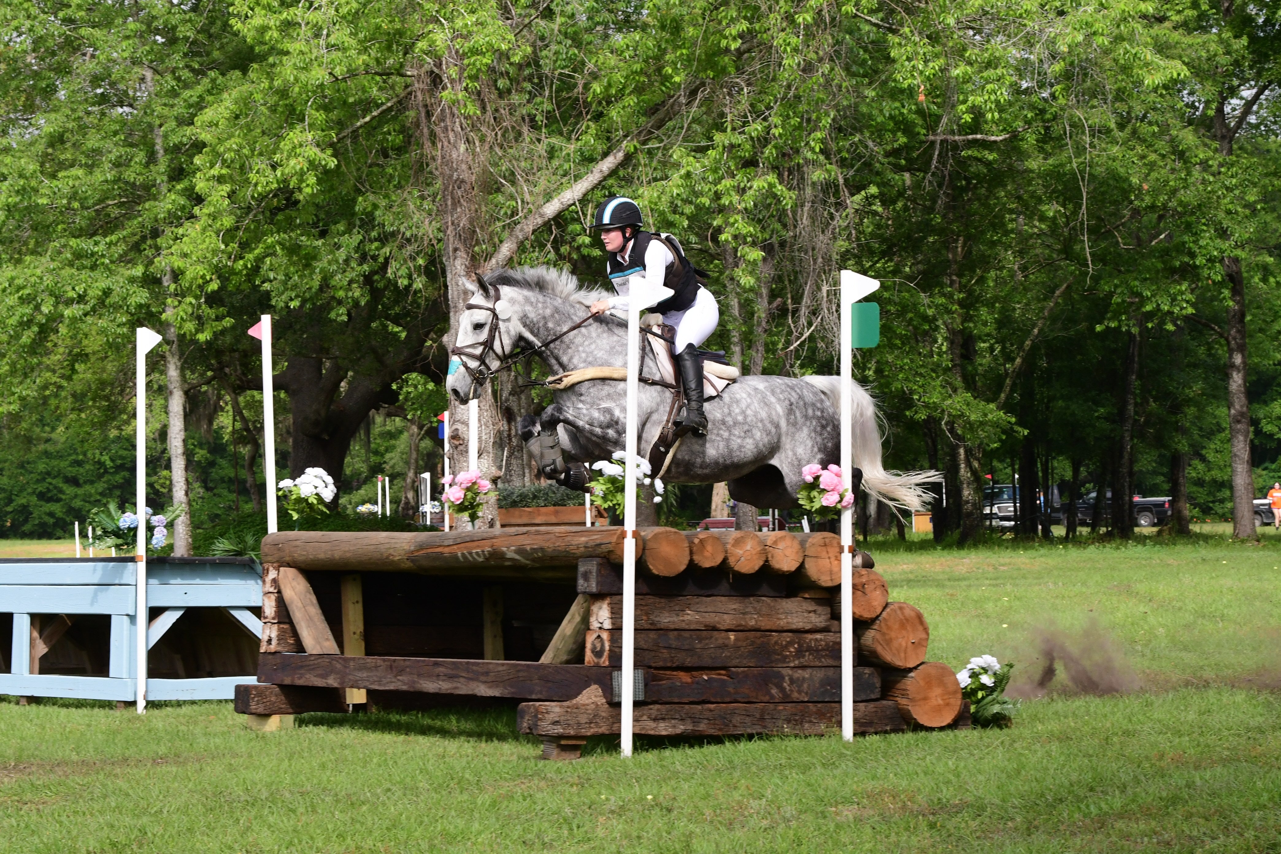 Ivie Cullen Dean jumping cross country wearing Divine Equestrian White Sweet Lady Sun Shirt and White Dignified Competition Breeches