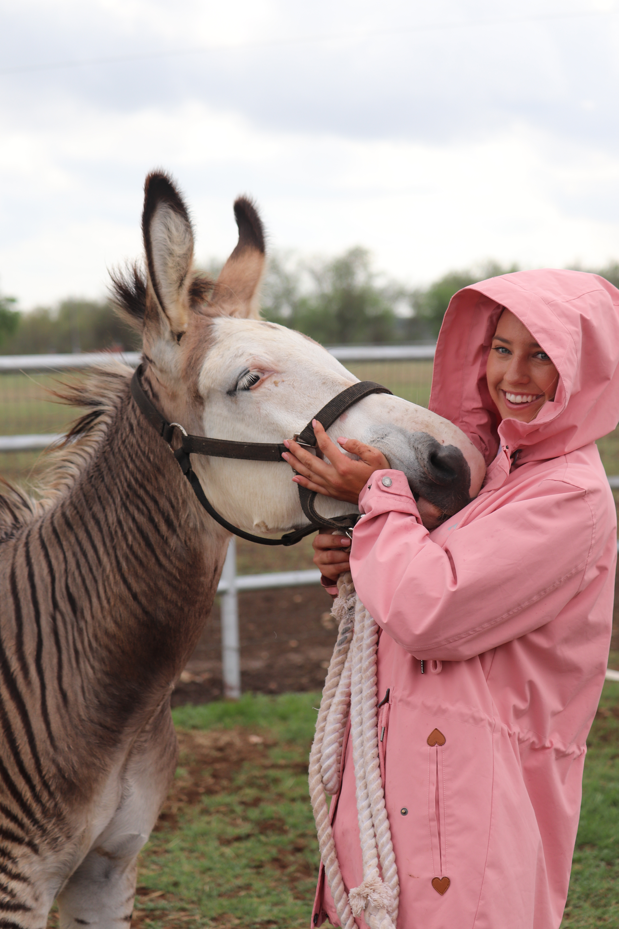 Anna giving Zebediah the Zedonk a hug wearing Divine Equestrian Pink 2 in 1 Jacket