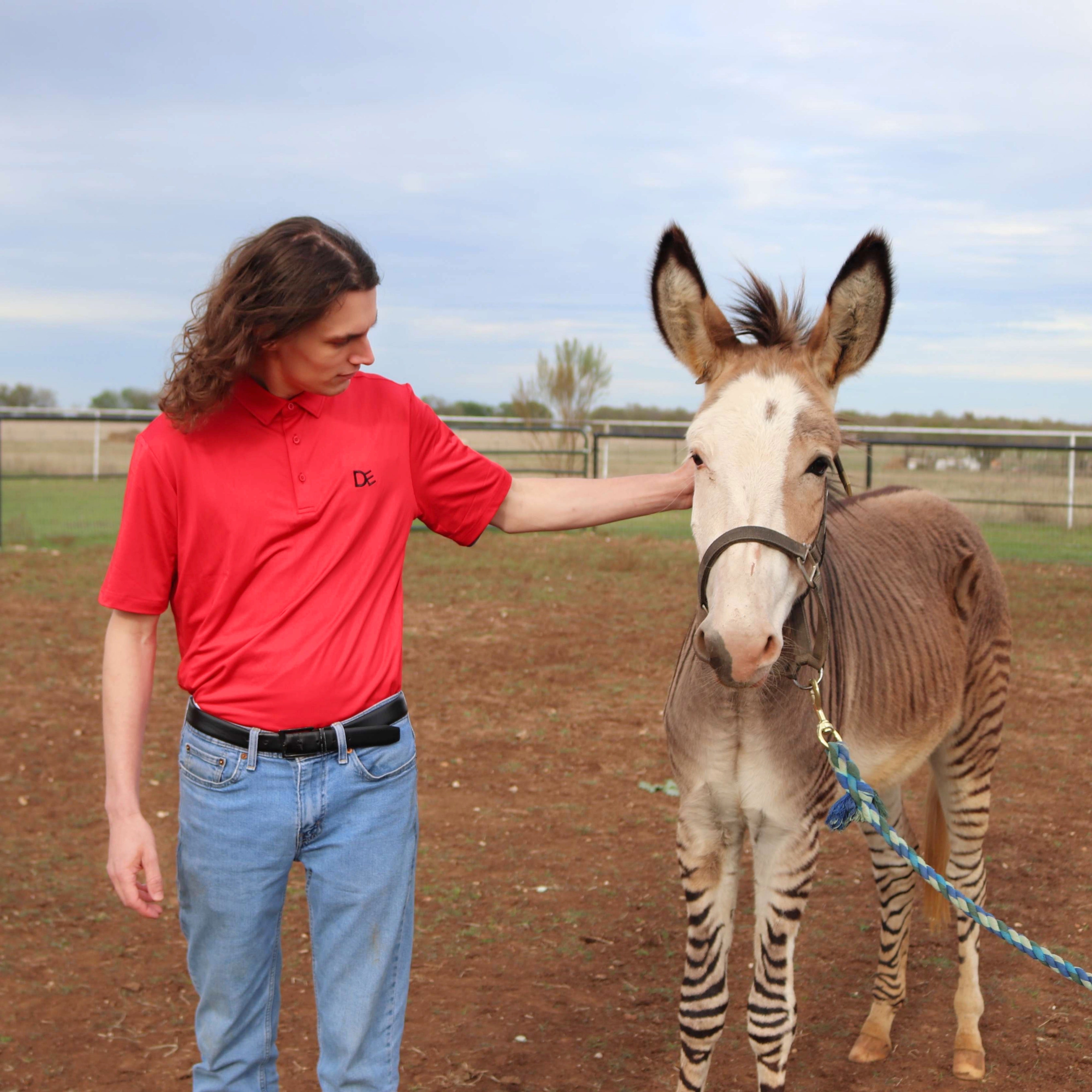 Coy wearing Divine Equestrian's Red Men's Polo