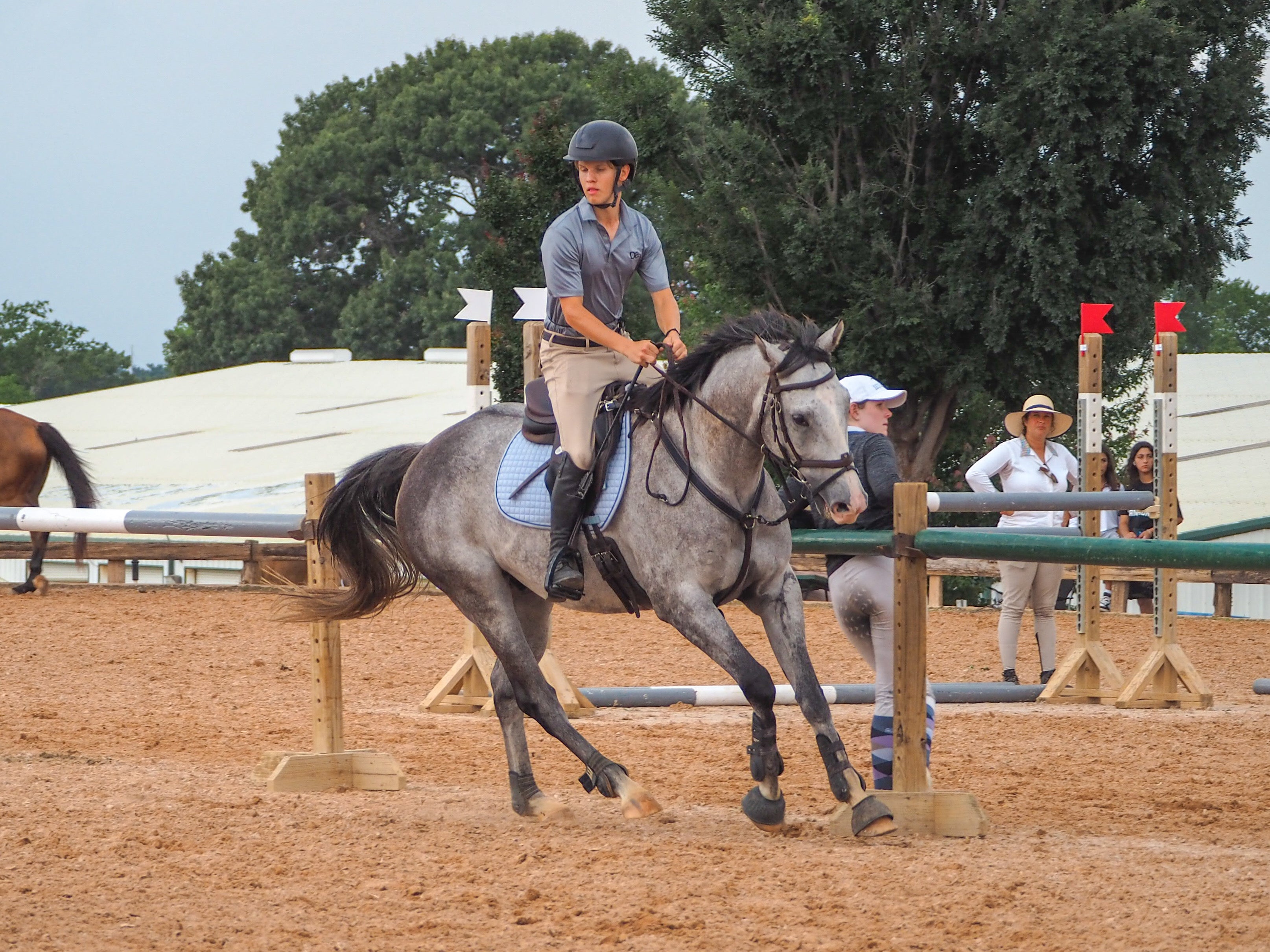 Brett Youssi wearing Divine Equestrian Men's Gray Polo and Beige Men's Breeches