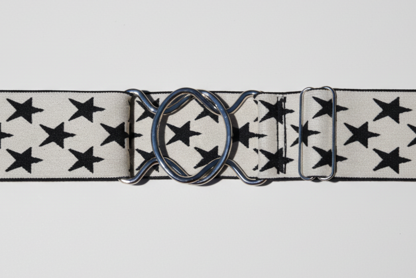Belt with star pattern and large buckle on a white background